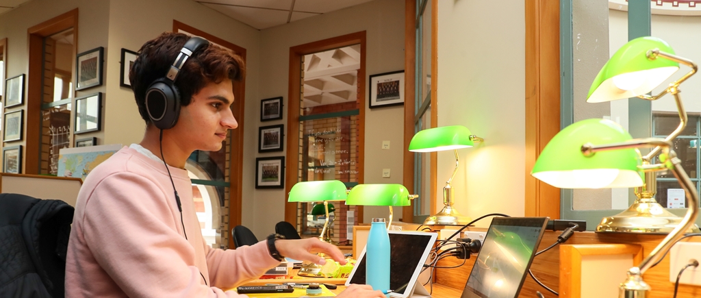 King's College student engages in Distance Learning on his laptop