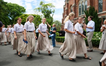 Students walk down drive