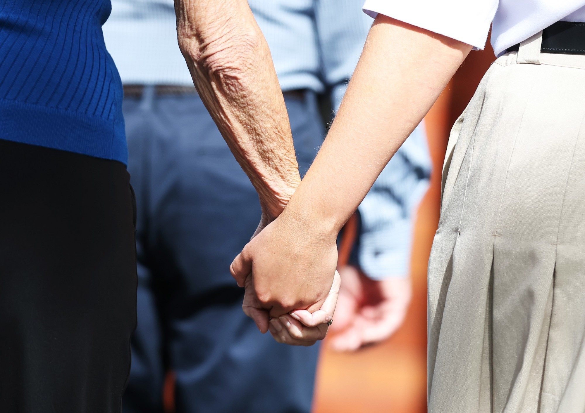 Granddaughter holding hands with Grandparent