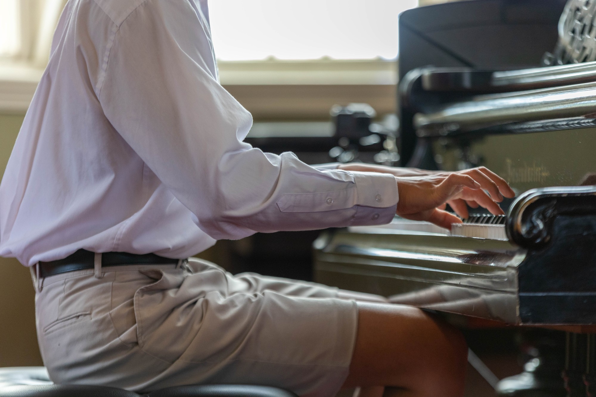 Student sitting playing the piano